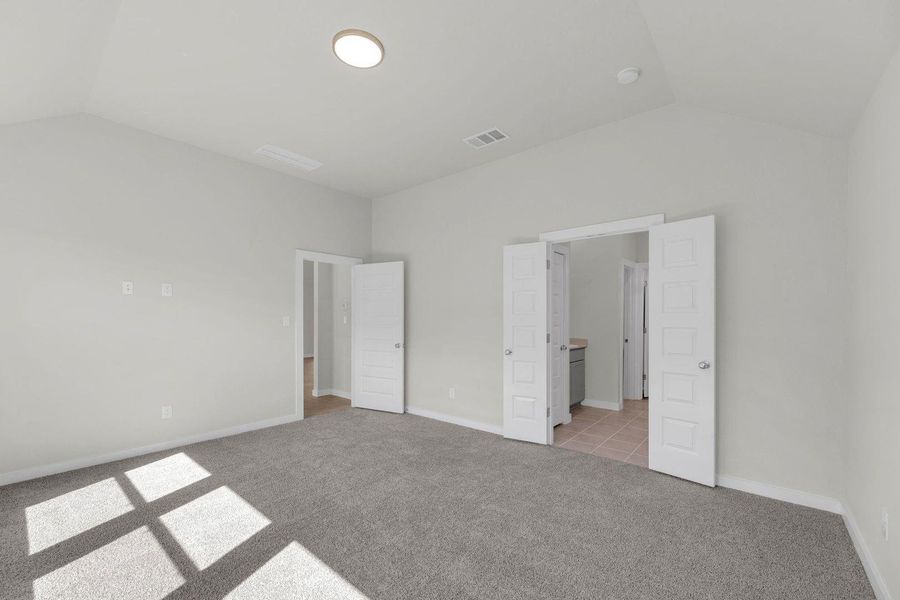 Primary Bedroom in the Pecos home plan by Trophy Signature Homes – REPRESENTATIVE PHOTO