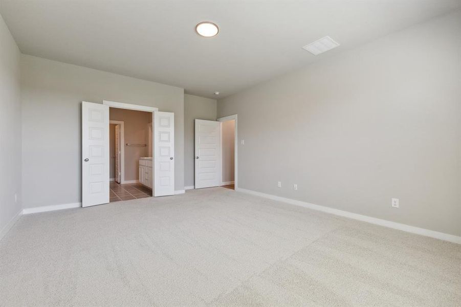 Primary bedroom in the Masters home plan by Trophy Signature Homes – REPRESENTATIVE PHOTO