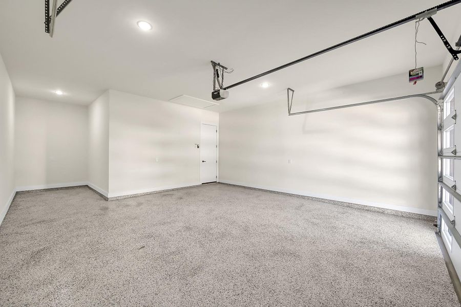 Oversized 2 car garage with epoxy coated floors and room for a golf cart or workshop.