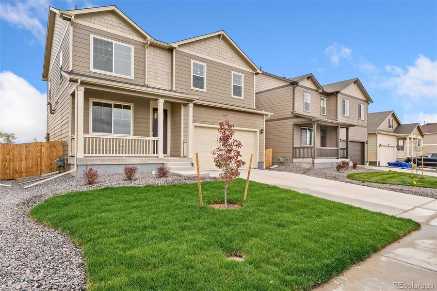 Front exterior of a new home in Spring Valley Ranch, Elizabeth, CO, highlighting curb appeal (Image 15).