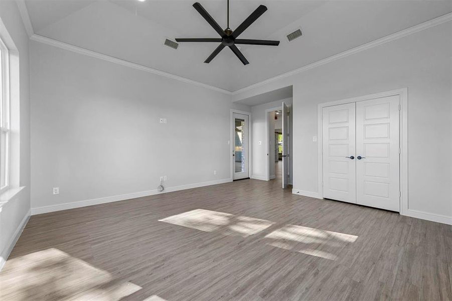 Unfurnished bedroom with crown molding and light hardwood / wood-style flooring