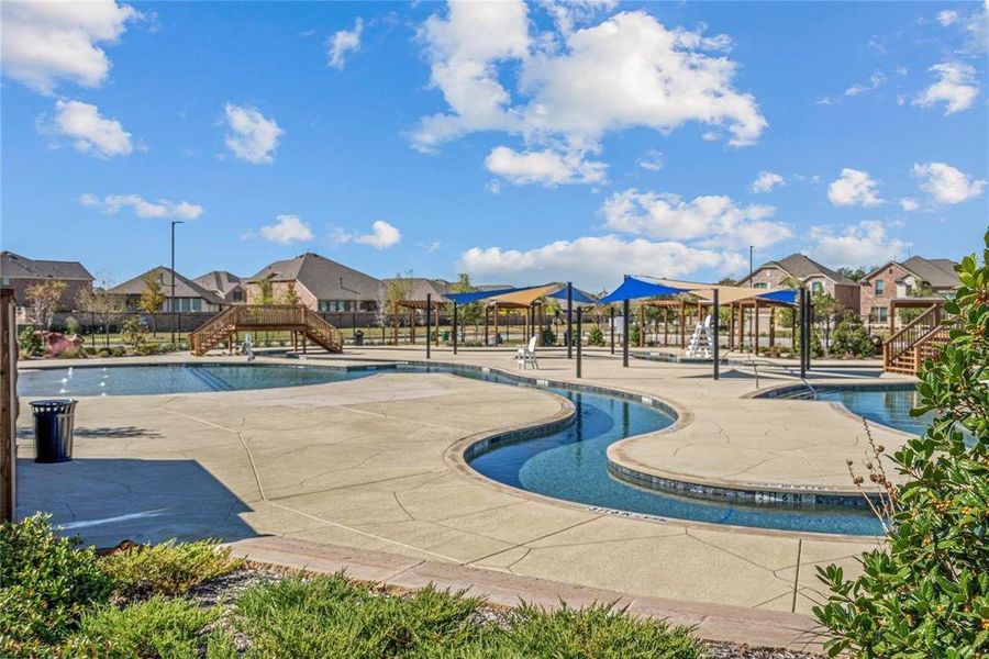 Community pool featuring stairway, a patio area, and a residential view