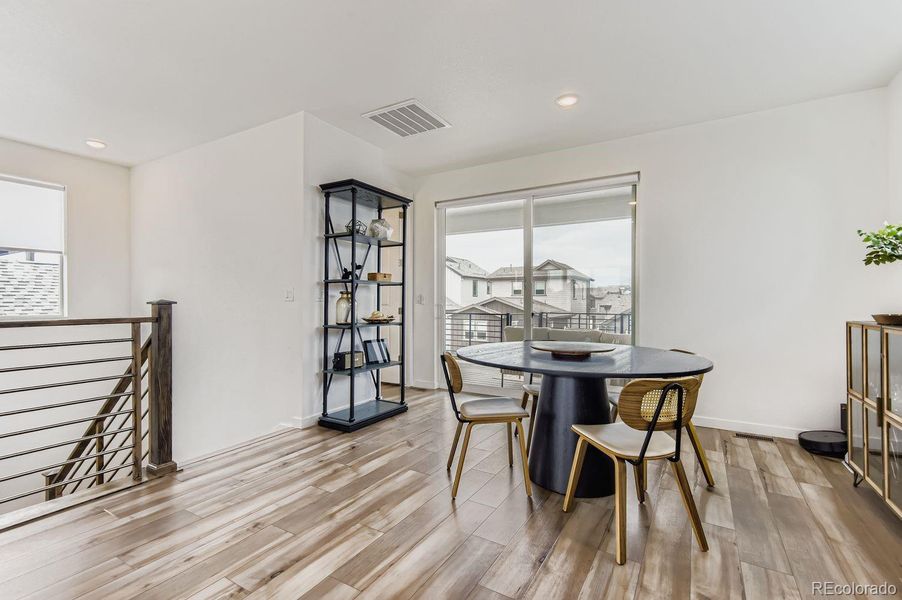 The spacious dining area, conveniently located beside the kitchen, creates a natural gathering space for meals, celebrations, and connection.