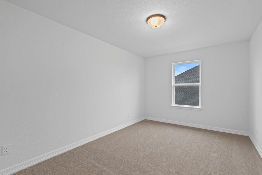 Your secondary bedroom features plush carpet, fresh paint, closet, and a large window that lets in plenty of natural lighting.