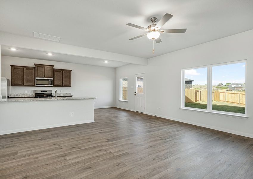 The kitchen, dining room and family room sit adjacent to one another.