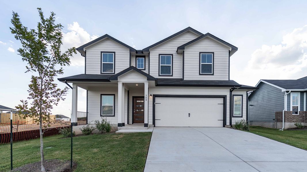 Front exterior of a new home in Paramount, Kyle, TX, highlighting curb appeal (Image 1).