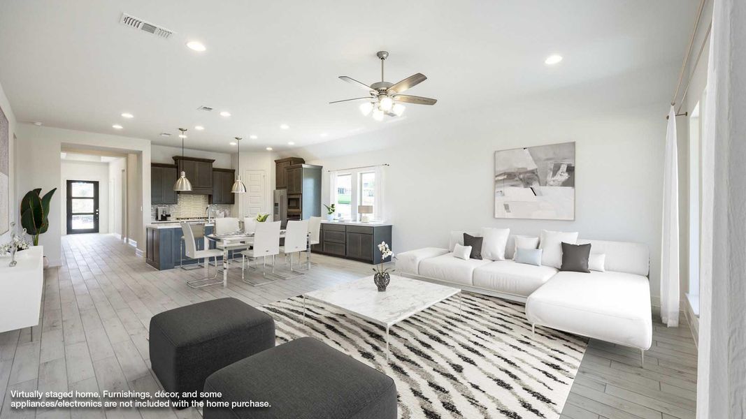 Living area featuring light wood-style flooring, ceiling fan, and recessed lighting Living area featuring light wood-style flooring, ceiling fan, and recessed lighting