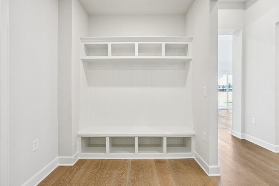 Mudroom with wood finished floors and baseboards