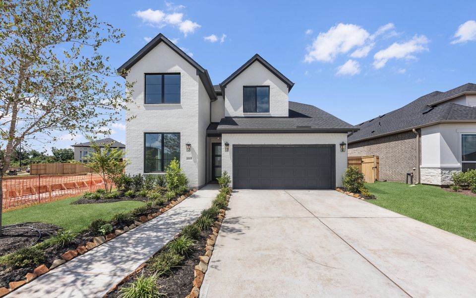 Front exterior of a new home in Sienna, Missouri City, TX, highlighting curb appeal (Image 2). Front exterior of a new home in Sienna, Missouri City, TX, highlighting curb appeal (Image 2).
