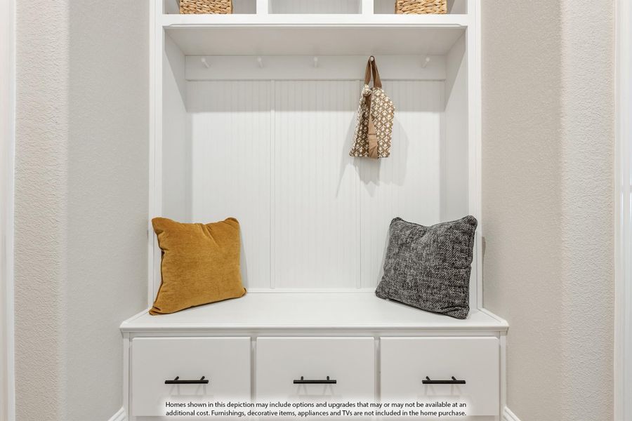 White mudroom built-in with bench seat, coat hooks, upper shelves, and three storage drawers below White mudroom built-in with bench seat, coat hooks, upper shelves, and three storage drawers below