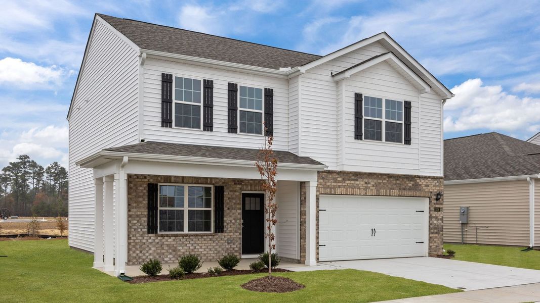 Front exterior of a new home in Ridgewood Farms, Winterville, NC, highlighting curb appeal (Image 2).
