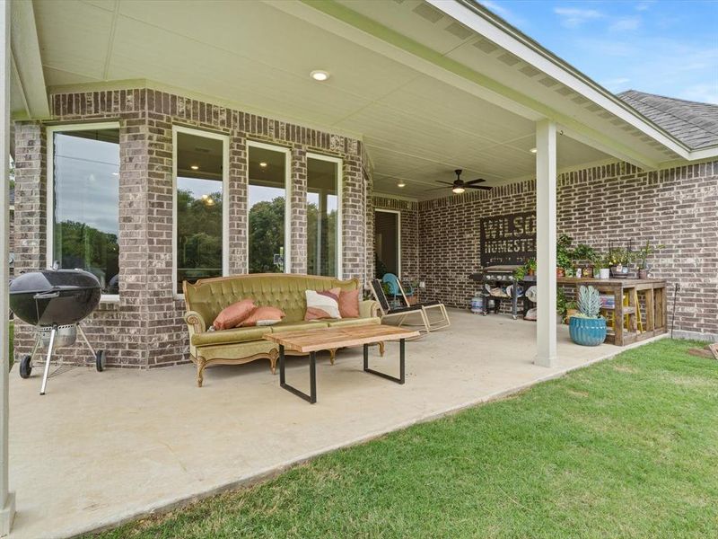 Back patio with extended concrete, offering additional space for outdoor seating and entertaining.