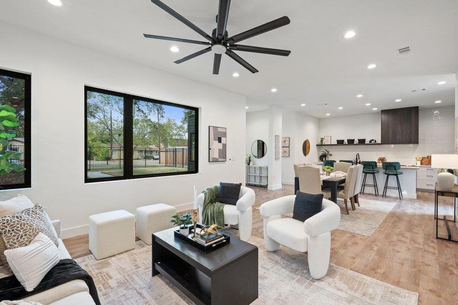 Living area featuring recessed lighting, light wood-type flooring, and a ceiling fan