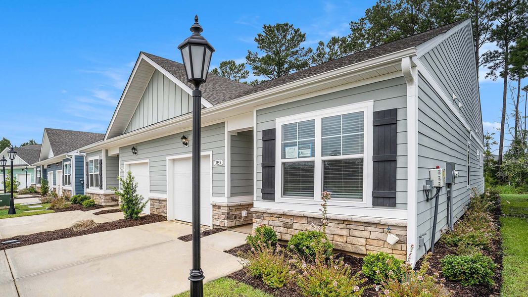 Front exterior of a new home in Brunswick Plantation, Ash, NC, highlighting curb appeal (Image 20).