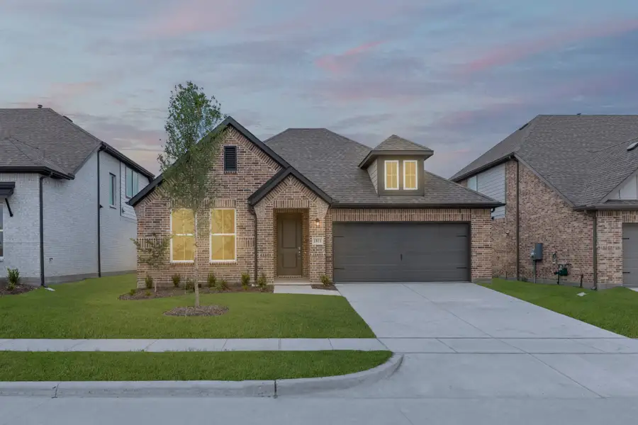 Front exterior of a new home in Walden Pond, Forney, TX, highlighting curb appeal (Image 2). Front exterior of a new home in Walden Pond, Forney, TX, highlighting curb appeal (Image 2).