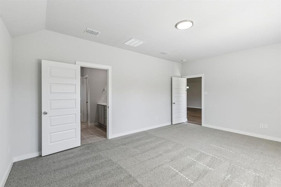 Primary Suite in the Oscar home plan by Trophy Signature Homes – REPRESENTATIVE PHOTO