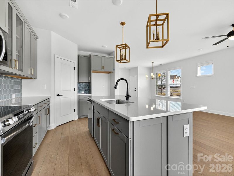 42" cabinets with soft close doors and drawers, quartz countertops, tile backsplash. Frigidaire gallery appliances. Microwave is exhaust vented to the outside. Large pantry with solid shelving