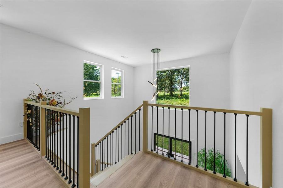 Stairs featuring wood finished floors and baseboards Stairs featuring wood finished floors and baseboards