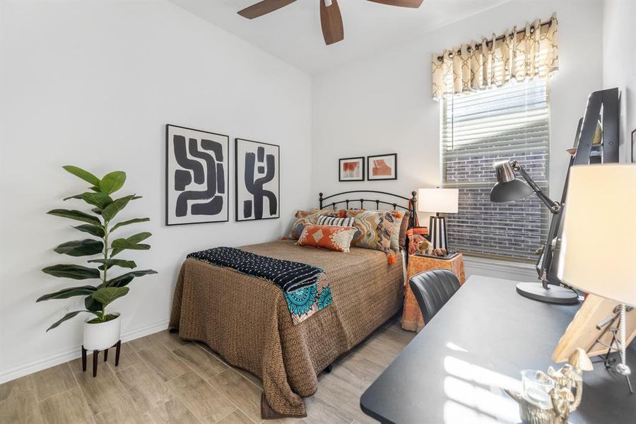 Bedroom with wood finished floors and a ceiling fan Bedroom with wood finished floors and a ceiling fan