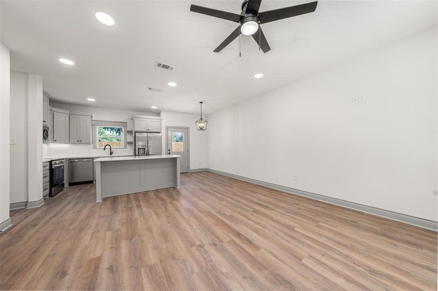 Unfurnished living room featuring recessed lighting, light wood-style flooring, and ceiling fan