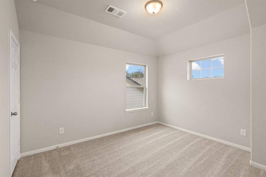 Your secondary bedroom features plush carpet, fresh paint, closet, and a large window that lets in plenty of natural lighting.