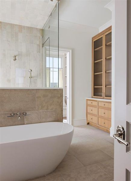 Bathroom featuring a freestanding bath, walk in shower, light tile patterned floors, and vanity Bathroom featuring a freestanding bath, walk in shower, light tile patterned floors, and vanity