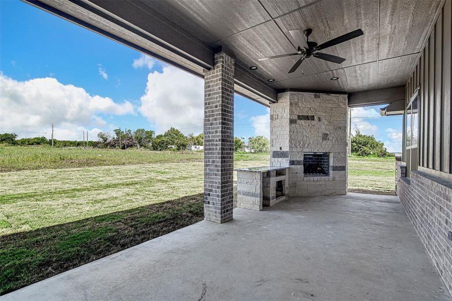 View of patio featuring ceiling fan and exterior kitchen