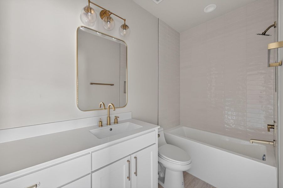 Modern fixtures and clean lines define this elegant full bathroom.