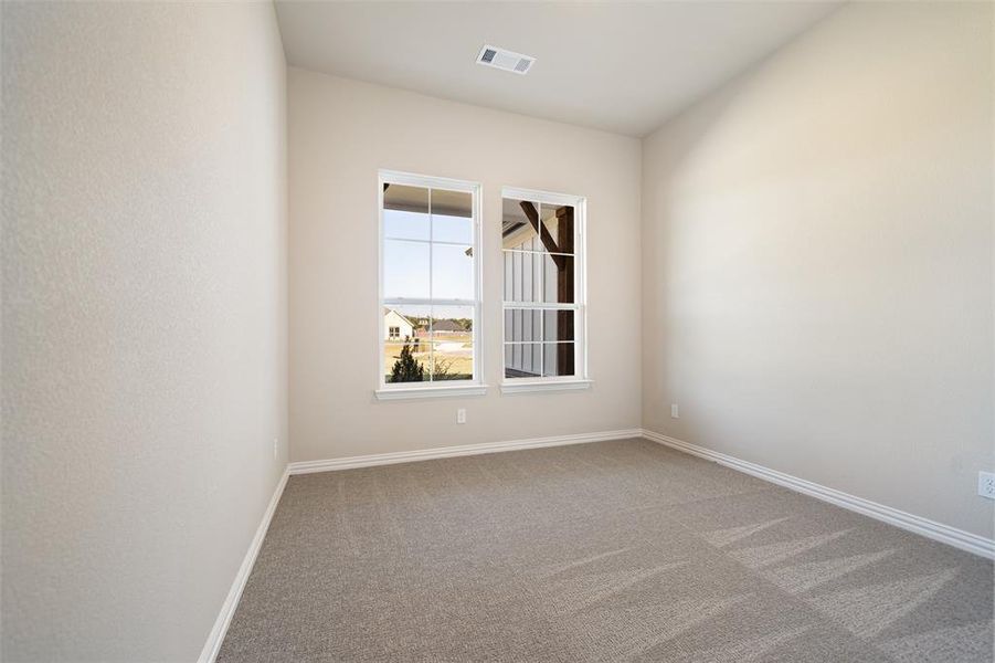 Unfurnished room with carpet flooring and baseboards