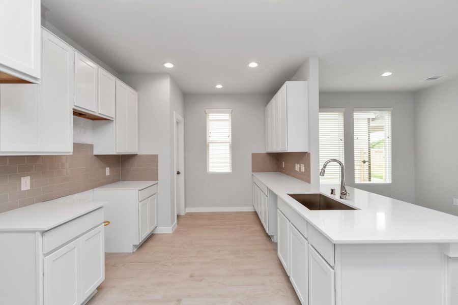 Welcome to a dream kitchen that exceeds expectations! Sample photo of completed home with similar floor plan. Actual colors and selections may vary.