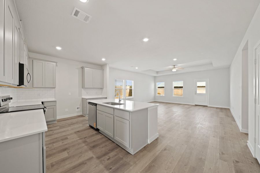 A large kitchen with white cabinets. A large kitchen with white cabinets.