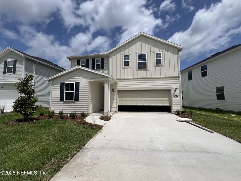 Front exterior of a new home in Panther Creek, Jacksonville, FL, highlighting curb appeal (Image 1). Front exterior of a new home in Panther Creek, Jacksonville, FL, highlighting curb appeal (Image 1).