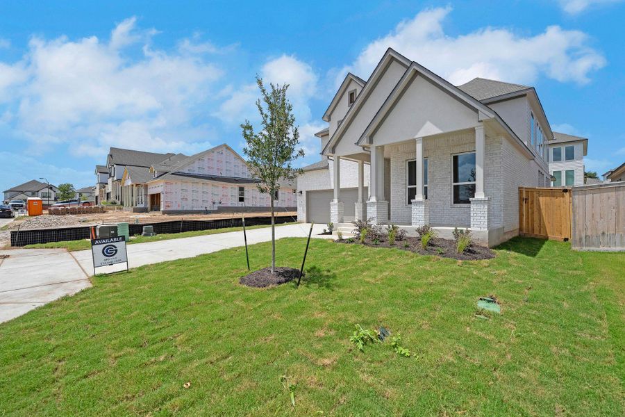 View of property exterior featuring concrete driveway, brick siding, a garage, and covered porch View of property exterior featuring concrete driveway, brick siding, a garage, and covered porch