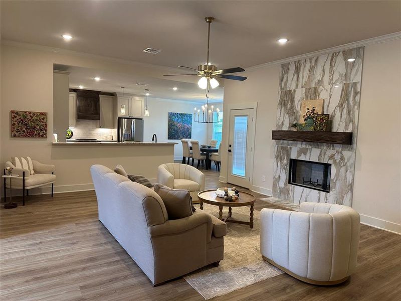 Living area featuring a fireplace with a large-format tile surround and a wood mantel