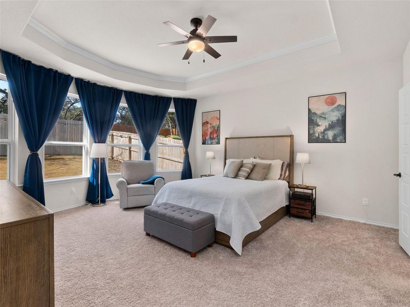 Bedroom with a ceiling fan, and light carpet