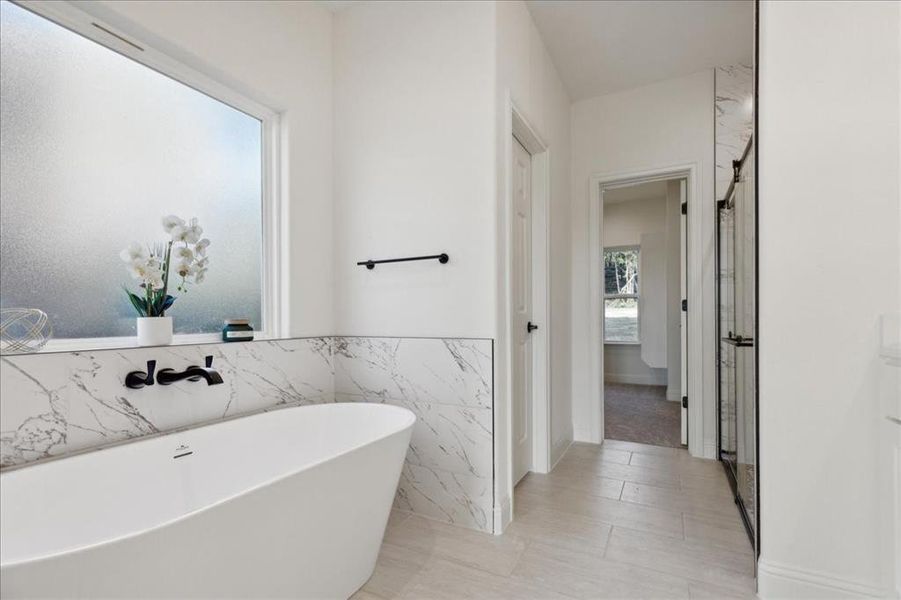 Bathroom with tile walls and a bathtub