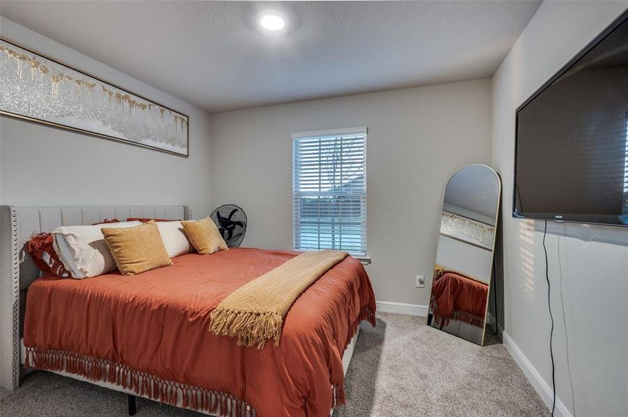 Bedroom with carpet floors and baseboards