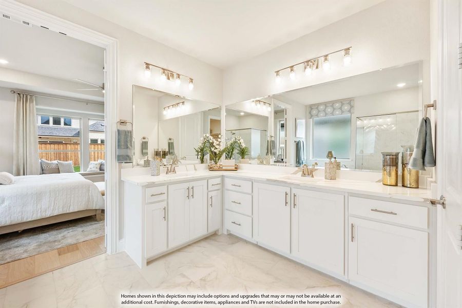 Master bathroom with dual vanities, white cabinets, large mirrors, and view into the bedroom
