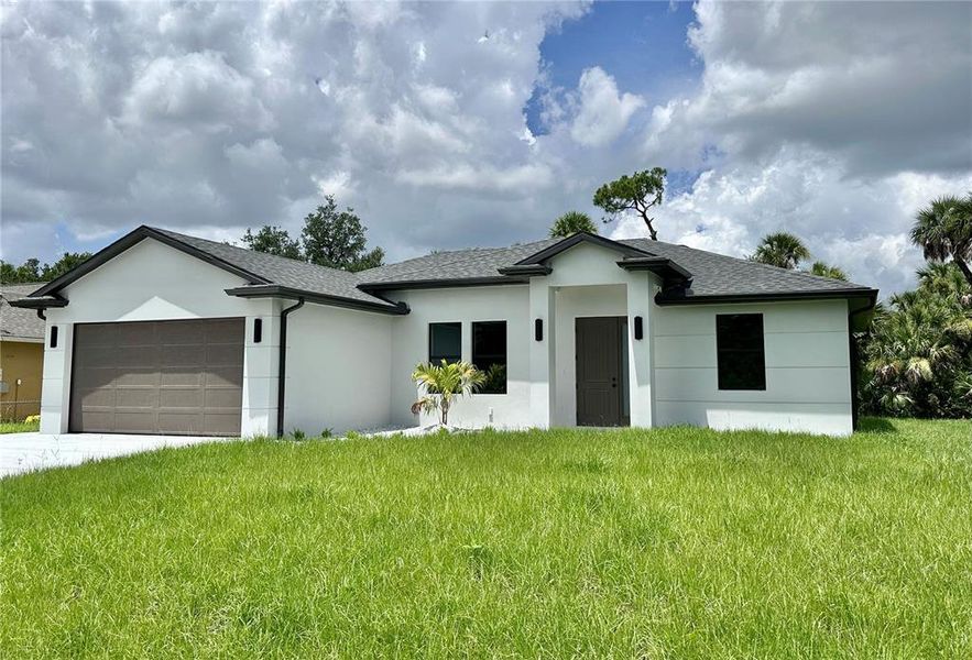 Front exterior of a new home in , North Port, FL, highlighting curb appeal (Image 1).