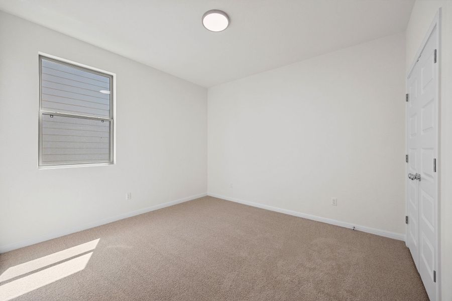 Bedroom in the Elm home plan by Trophy Signature Homes – REPRESENTATIVE PHOTO