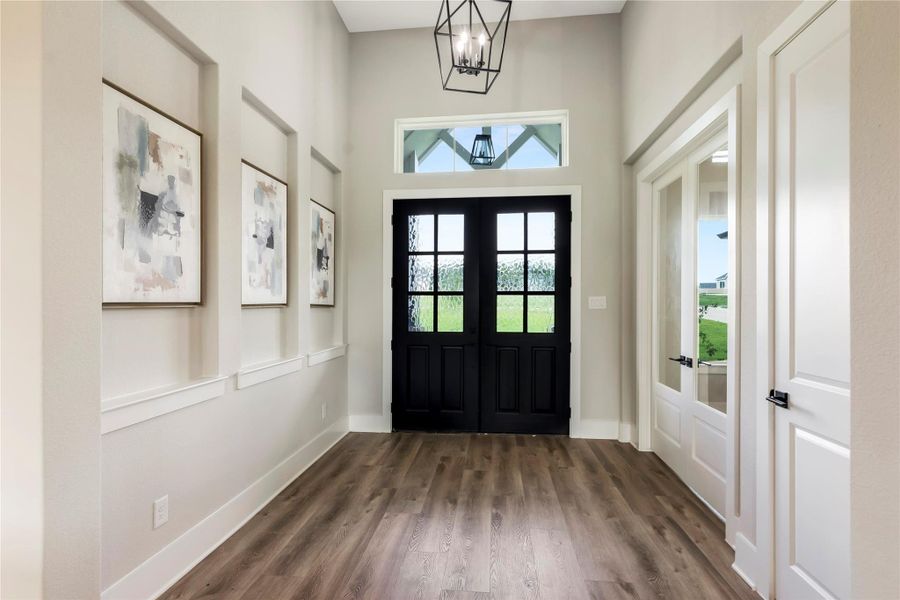 Elegant foyer with stylish double doors creating a welcoming entrance.