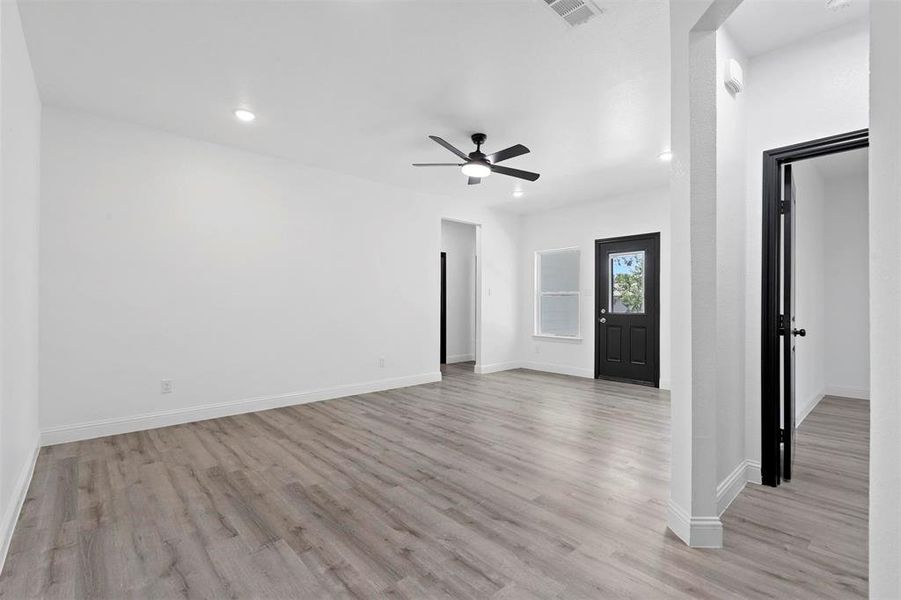 Empty room featuring ceiling fan and light hardwood / wood-style flooring