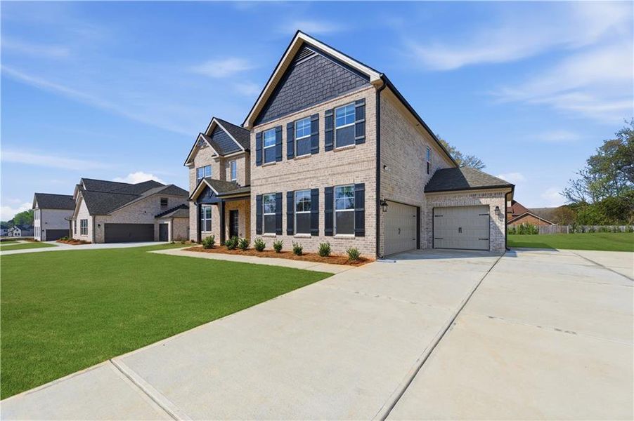 Front exterior of a new home in Cambria at Traditions, Hampton, GA, highlighting curb appeal (Image 17). Front exterior of a new home in Cambria at Traditions, Hampton, GA, highlighting curb appeal (Image 17).