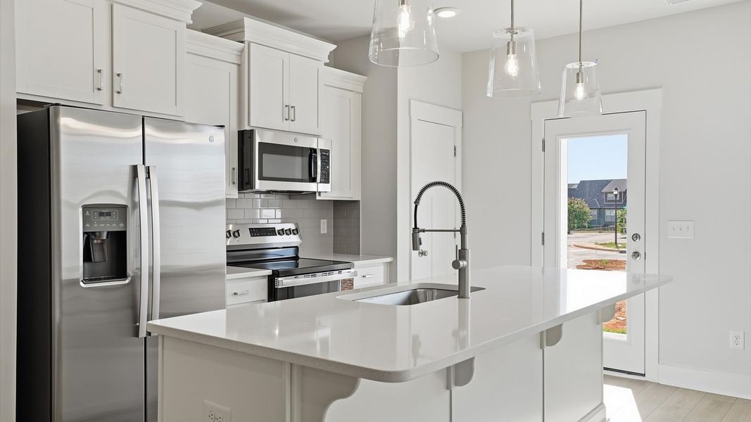 Elegant and compact island anchors this tasteful kitchen with high standards and timeless appeal in Simpsonville, SC