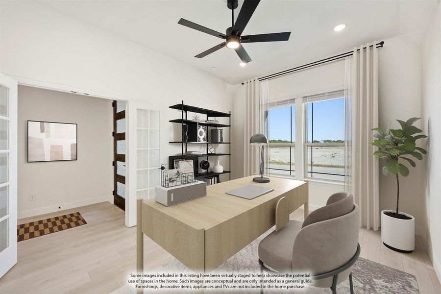 Home office with wood desk, black ceiling fan, open shelving, and large window with natural light Home office with wood desk, black ceiling fan, open shelving, and large window with natural light