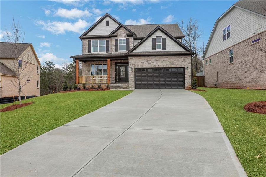 Front exterior of a new home in Cambridge, Flowery Branch, GA, highlighting curb appeal (Image 1). Front exterior of a new home in Cambridge, Flowery Branch, GA, highlighting curb appeal (Image 1).