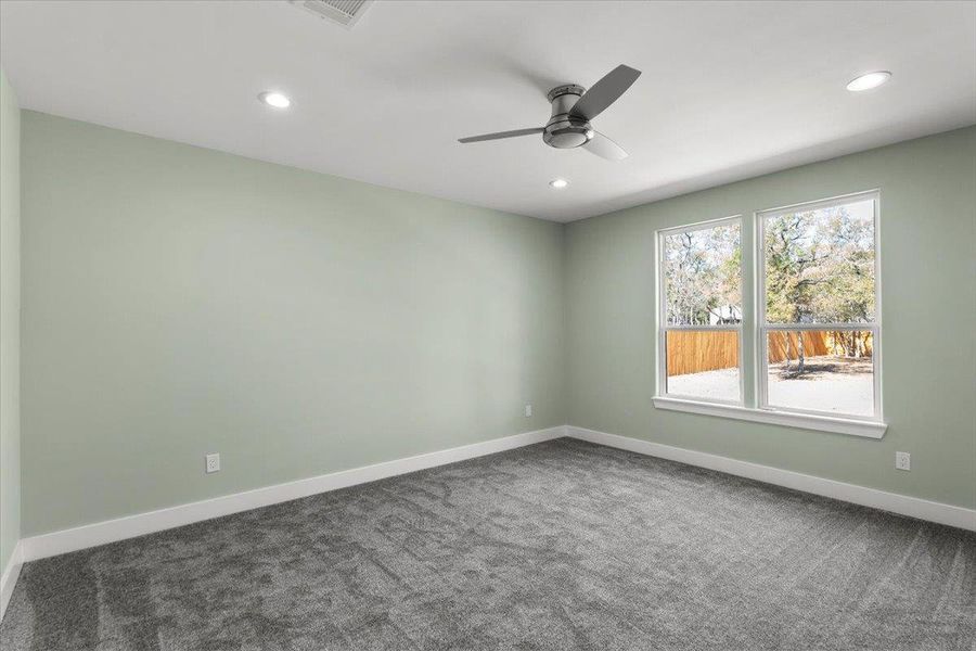 Primary bedroom with recessed lighting and ceiling fan