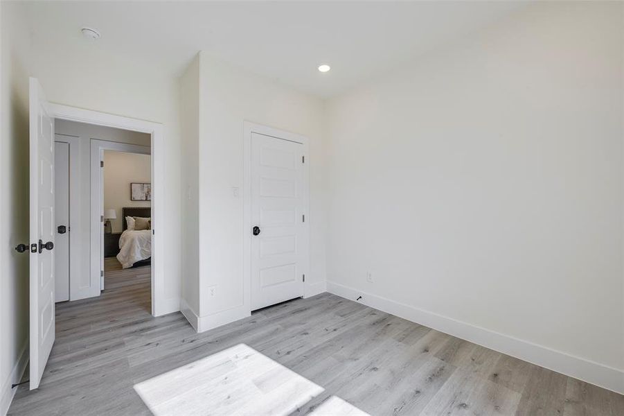 Unfurnished bedroom featuring light wood finished floors and recessed lighting