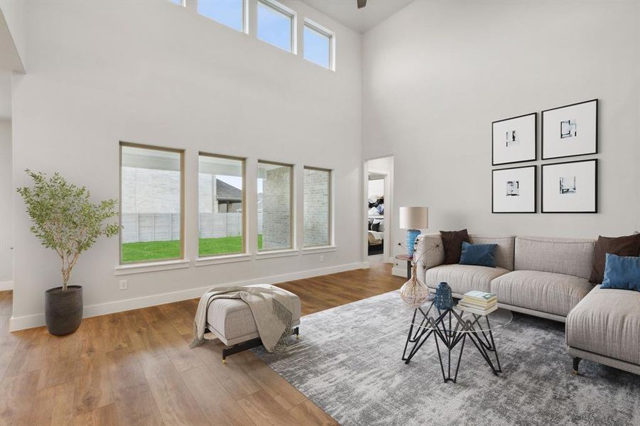 Living room with hardwood / wood-style floors and a towering ceiling