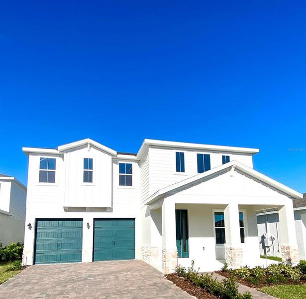 Front exterior of a new home in Summerlake Reserve, Winter Garden, FL, highlighting curb appeal (Image 1).